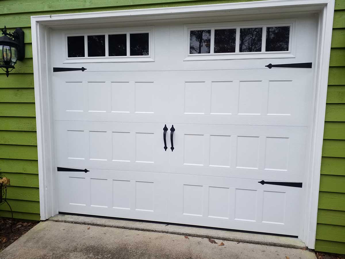 White garage door with decorative hinges and handles